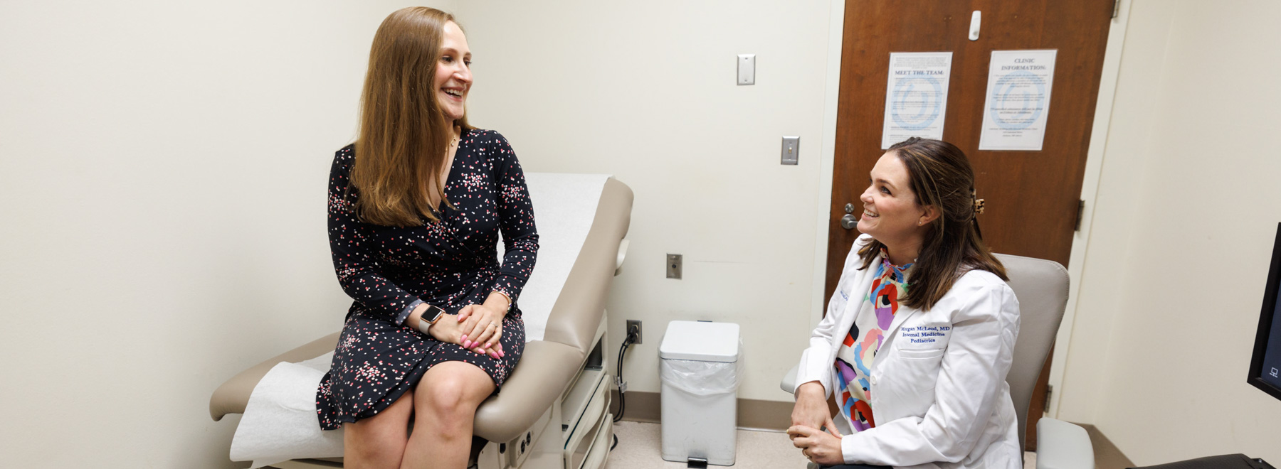 Provider and patient talking in exam room.